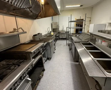 Commercial kitchen aisle and stainless work surfaces