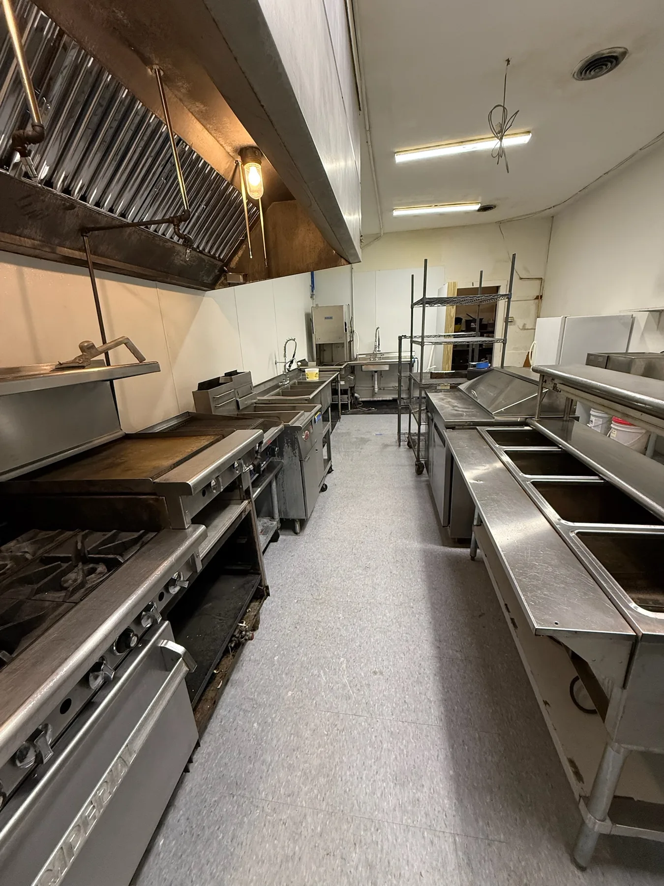 Commercial kitchen aisle and stainless work surfaces